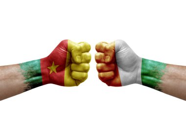 Two hands punch to each others on white background. Country flags painted fists, conflict crisis concept between cameroon and ivory coast