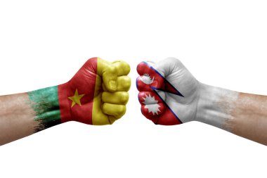 Two hands punch to each others on white background. Country flags painted fists, conflict crisis concept between cameroon and nepal