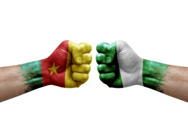 Two hands punch to each others on white background. Country flags painted fists, conflict crisis concept between cameroon and nigeria