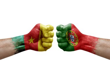 Two hands punch to each others on white background. Country flags painted fists, conflict crisis concept between cameroon and portugal