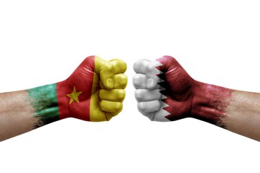 Two hands punch to each others on white background. Country flags painted fists, conflict crisis concept between cameroon and qatar