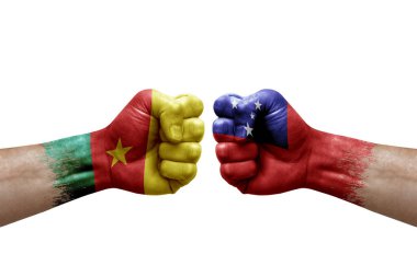 Two hands punch to each others on white background. Country flags painted fists, conflict crisis concept between cameroon and samoa