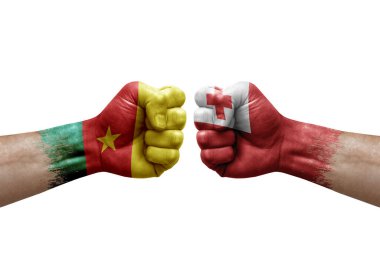 Two hands punch to each others on white background. Country flags painted fists, conflict crisis concept between cameroon and tonga