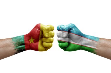 Two hands punch to each others on white background. Country flags painted fists, conflict crisis concept between cameroon and uzbekistan