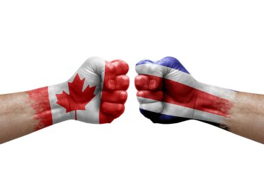 Two hands punch to each others on white background. Country flags painted fists, conflict crisis concept between canada and costa rica