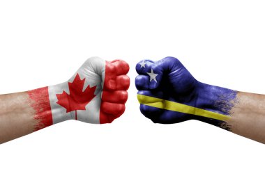 Two hands punch to each others on white background. Country flags painted fists, conflict crisis concept between canada and curacao