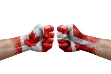 Two hands punch to each others on white background. Country flags painted fists, conflict crisis concept between canada and denmark