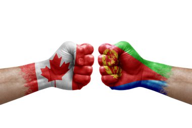 Two hands punch to each others on white background. Country flags painted fists, conflict crisis concept between canada and eritrea