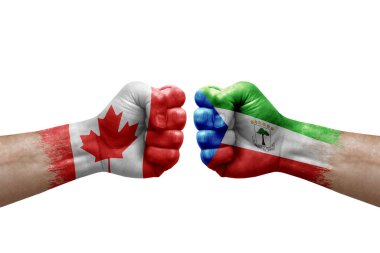 Two hands punch to each others on white background. Country flags painted fists, conflict crisis concept between canada and equatorial guinea
