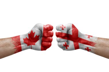 Two hands punch to each others on white background. Country flags painted fists, conflict crisis concept between canada and georgia