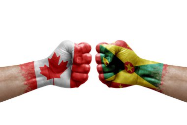 Two hands punch to each others on white background. Country flags painted fists, conflict crisis concept between canada and grenada