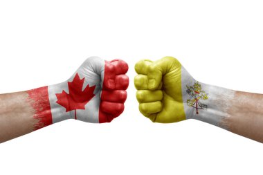 Two hands punch to each others on white background. Country flags painted fists, conflict crisis concept between canada and holy see