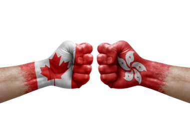 Two hands punch to each others on white background. Country flags painted fists, conflict crisis concept between canada and hong kong