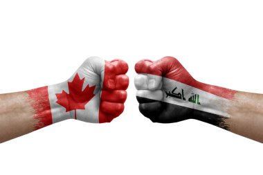 Two hands punch to each others on white background. Country flags painted fists, conflict crisis concept between canada and iraq