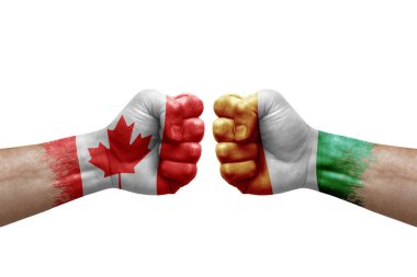 Two hands punch to each others on white background. Country flags painted fists, conflict crisis concept between canada and ivory coast