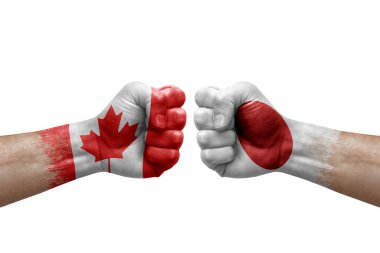 Two hands punch to each others on white background. Country flags painted fists, conflict crisis concept between canada and japan
