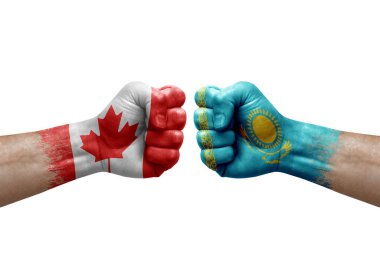 Two hands punch to each others on white background. Country flags painted fists, conflict crisis concept between canada and kazakhstan