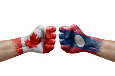 Two hands punch to each others on white background. Country flags painted fists, conflict crisis concept between canada and laos
