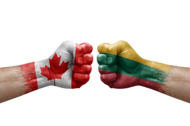 Two hands punch to each others on white background. Country flags painted fists, conflict crisis concept between canada and lithuania