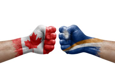 Two hands punch to each others on white background. Country flags painted fists, conflict crisis concept between canada and marshall islands