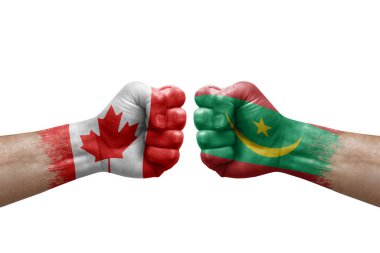 Two hands punch to each others on white background. Country flags painted fists, conflict crisis concept between canada and mauritania