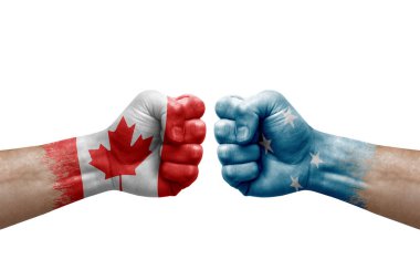 Two hands punch to each others on white background. Country flags painted fists, conflict crisis concept between canada and micronesia