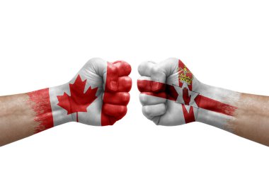 Two hands punch to each others on white background. Country flags painted fists, conflict crisis concept between canada and ireland
