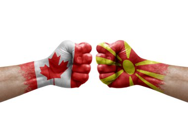 Two hands punch to each others on white background. Country flags painted fists, conflict crisis concept between canada and north macedonia