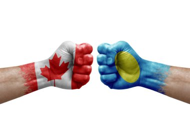 Two hands punch to each others on white background. Country flags painted fists, conflict crisis concept between canada and palau