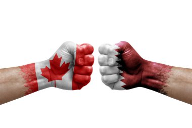 Two hands punch to each others on white background. Country flags painted fists, conflict crisis concept between canada and qatar