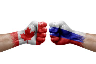 Two hands punch to each others on white background. Country flags painted fists, conflict crisis concept between canada and russia