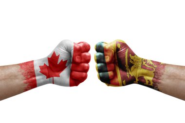 Two hands punch to each others on white background. Country flags painted fists, conflict crisis concept between canada and sri lanka