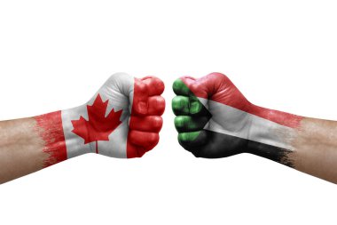 Two hands punch to each others on white background. Country flags painted fists, conflict crisis concept between canada and sudan