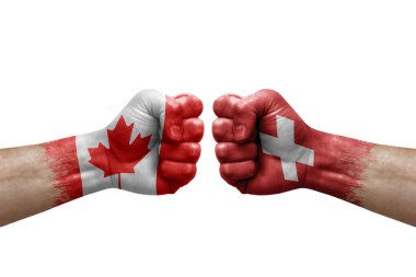 Two hands punch to each others on white background. Country flags painted fists, conflict crisis concept between canada and switzerland