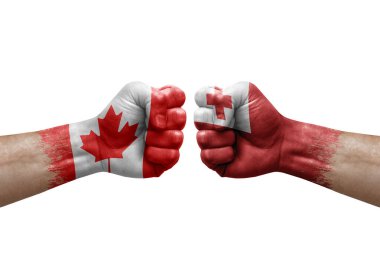 Two hands punch to each others on white background. Country flags painted fists, conflict crisis concept between canada and tonga