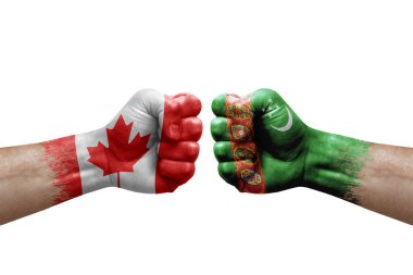 Two hands punch to each others on white background. Country flags painted fists, conflict crisis concept between canada and turkmenistan