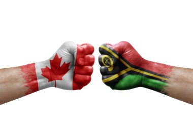 Two hands punch to each others on white background. Country flags painted fists, conflict crisis concept between canada and vanuatu