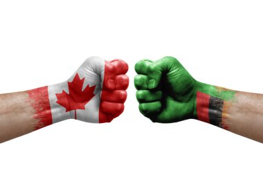 Two hands punch to each others on white background. Country flags painted fists, conflict crisis concept between canada and zambia