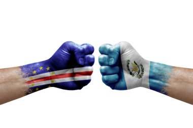 Two hands punch to each others on white background. Country flags painted fists, conflict crisis concept between cape verde and guatemala