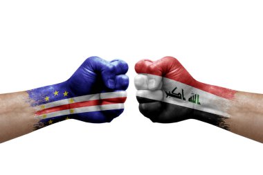 Two hands punch to each others on white background. Country flags painted fists, conflict crisis concept between cape verde and iraq