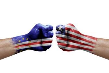 Two hands punch to each others on white background. Country flags painted fists, conflict crisis concept between cape verde and liberia