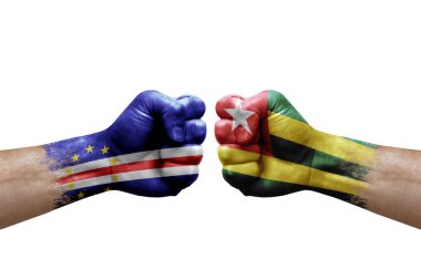 Two hands punch to each others on white background. Country flags painted fists, conflict crisis concept between cape verde and togo