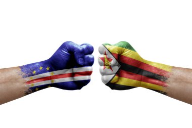 Two hands punch to each others on white background. Country flags painted fists, conflict crisis concept between cape verde and zimbabwe