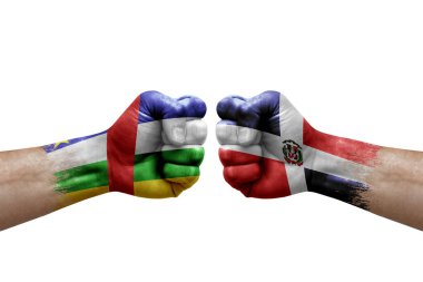 Two hands punch to each others on white background. Country flags painted fists, conflict crisis concept between central african republic and dominican republic