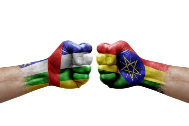 Two hands punch to each others on white background. Country flags painted fists, conflict crisis concept between central african republic and ethiopia