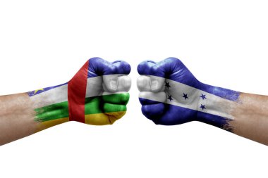 Two hands punch to each others on white background. Country flags painted fists, conflict crisis concept between central african republic and honduras