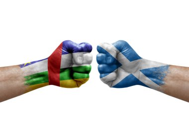 Two hands punch to each others on white background. Country flags painted fists, conflict crisis concept between central african republic and scotland
