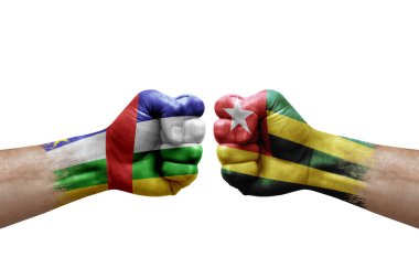 Two hands punch to each others on white background. Country flags painted fists, conflict crisis concept between central african republic and togo