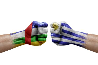 Two hands punch to each others on white background. Country flags painted fists, conflict crisis concept between central african republic and uruguay