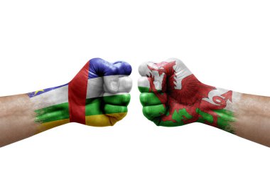 Two hands punch to each others on white background. Country flags painted fists, conflict crisis concept between central african republic and wales